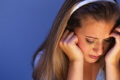 Adolescent Girl with Head in Hands